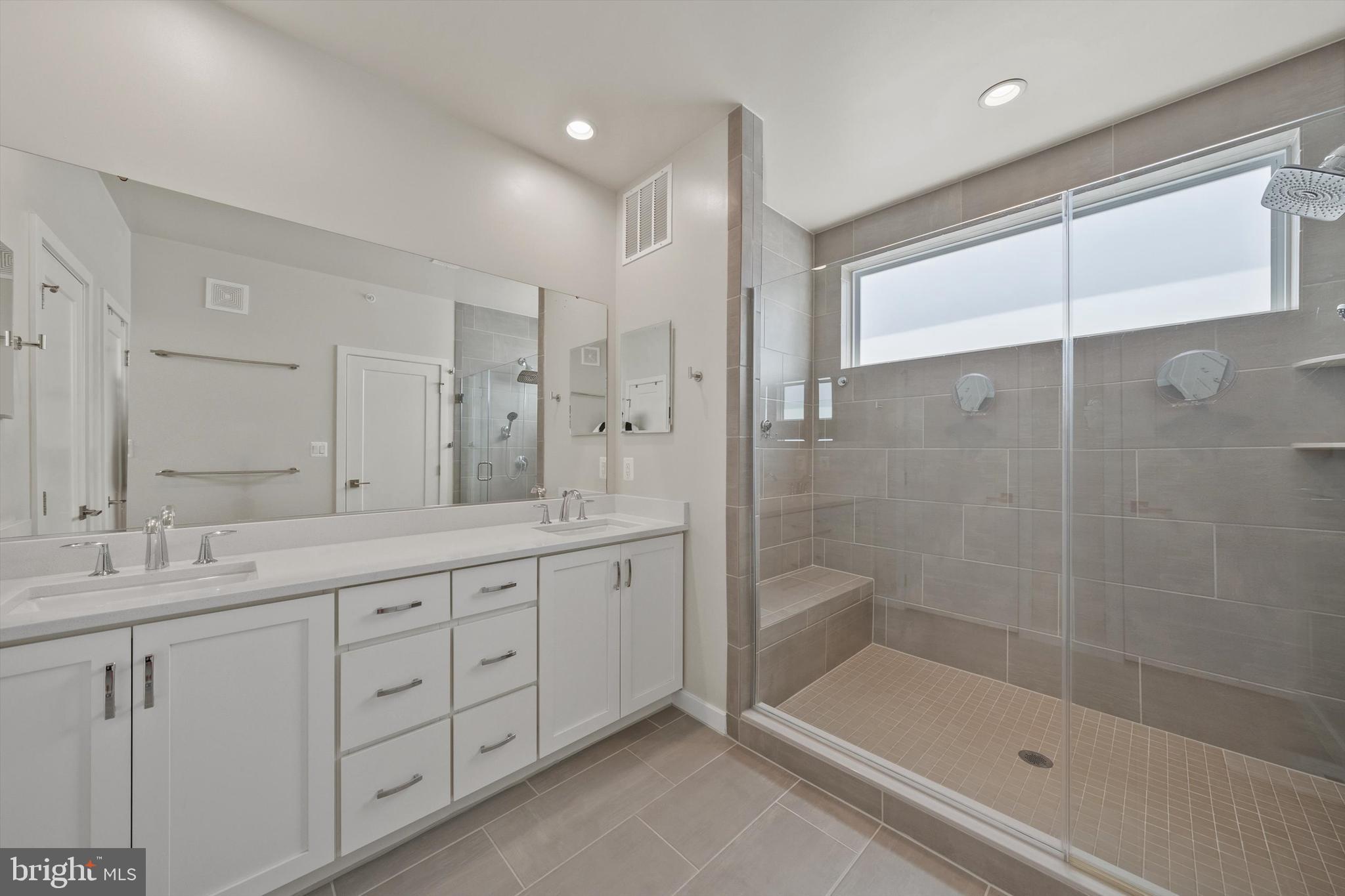 43179 Mongold Square Ashburn, VA 20148 - Photo 19 of 46 a bathroom with a shower sink and mirror