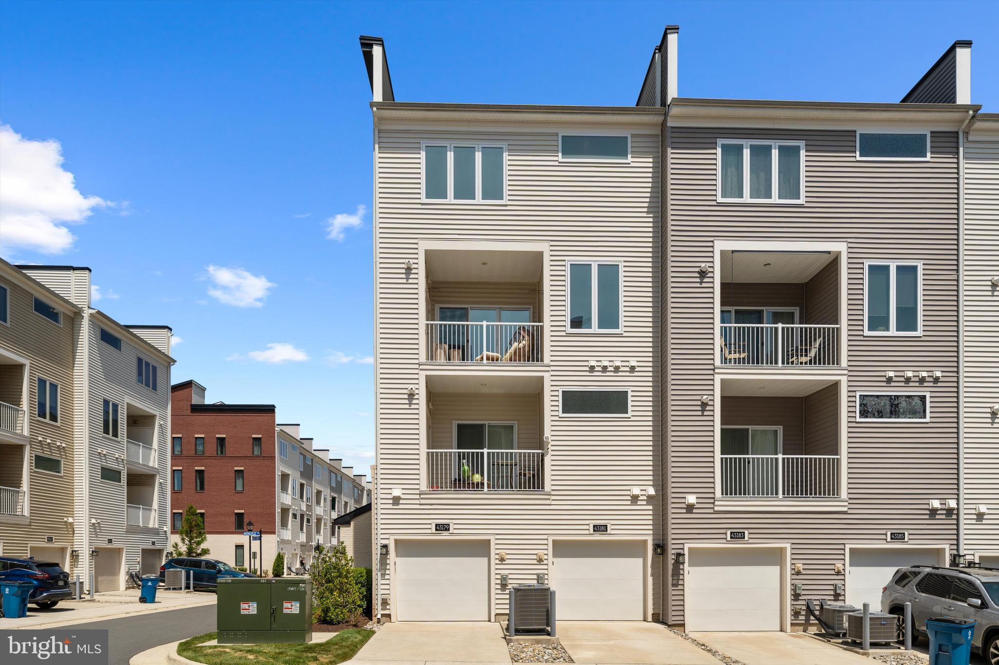 43179 Mongold Square Ashburn, VA 20148 - Photo 33 of 46 a front view of a residential apartment building with a yard