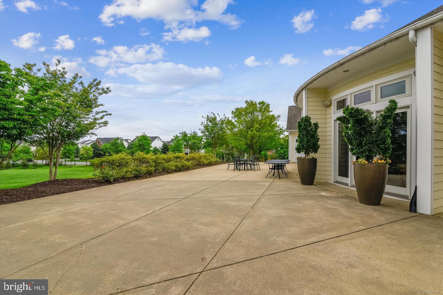 43179 Mongold Square Ashburn, VA 20148 - Photo 41 of 46 a view of a patio with a table and chairs and potted plants