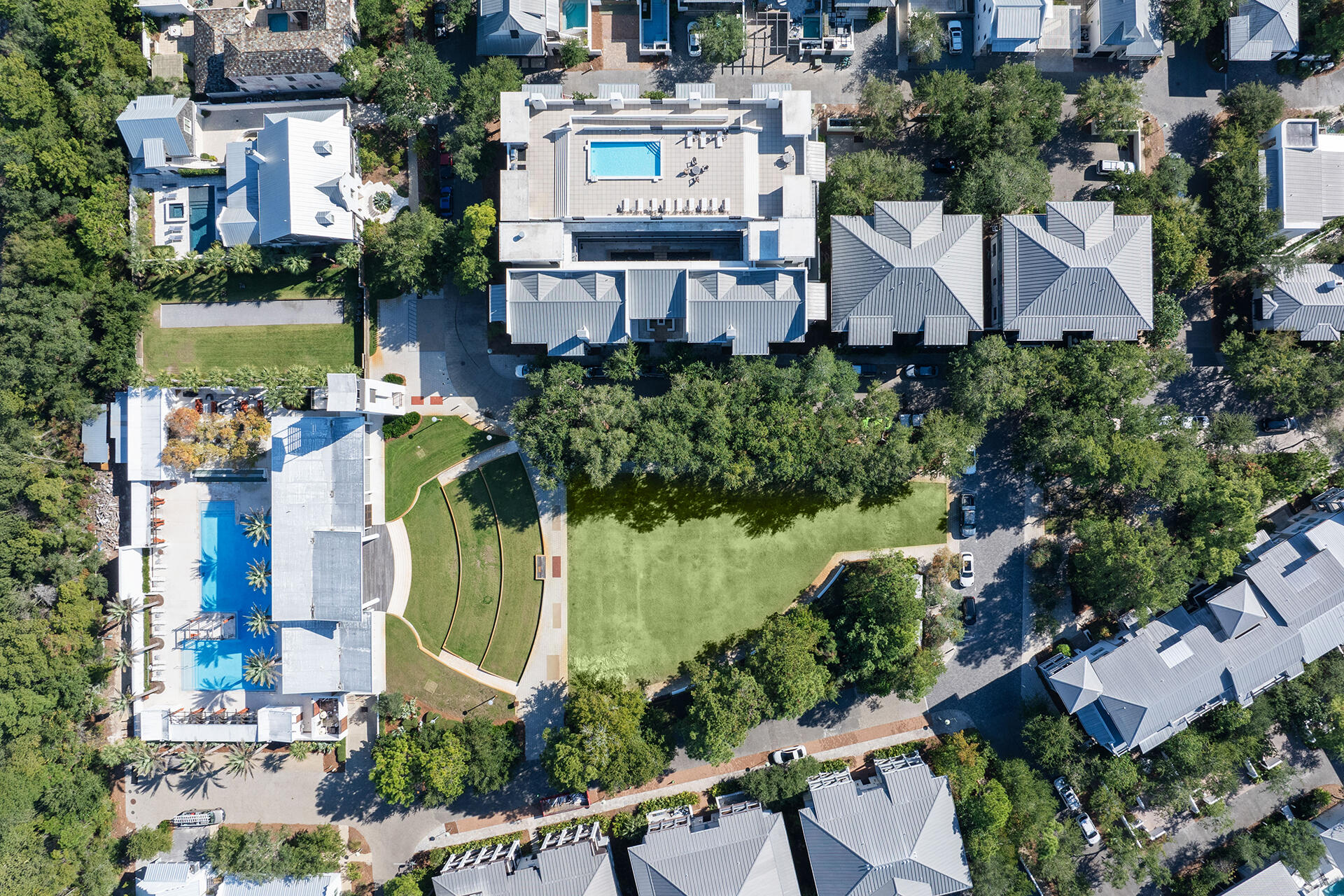 an aerial view of multiple houses with a yard