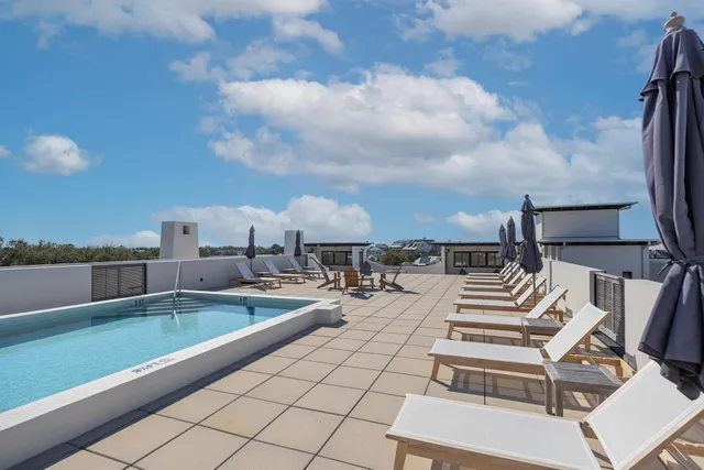 an aerial view of multiple houses with a yard