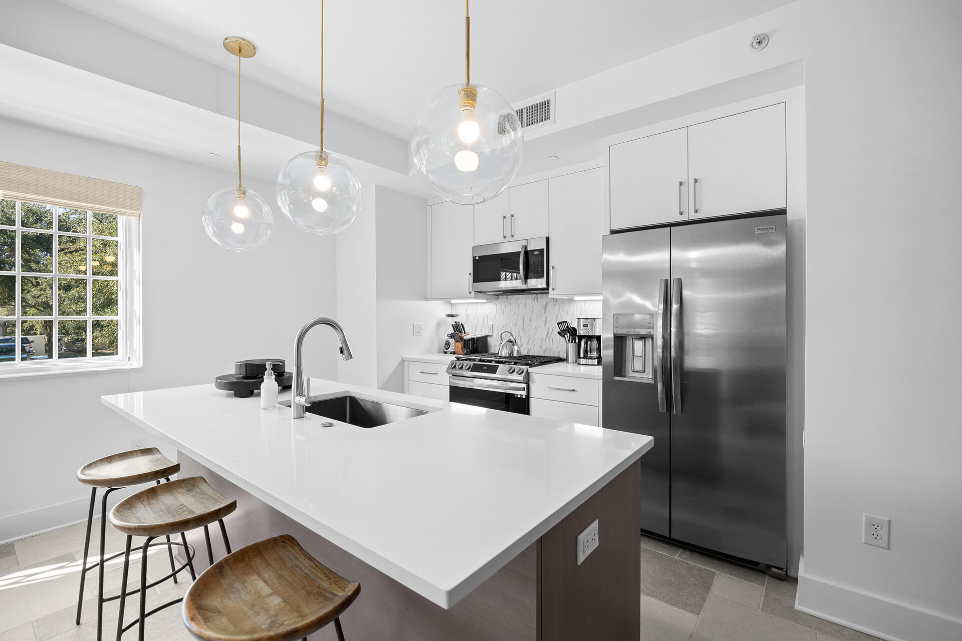 136 Georgetown Avenue, Unit E36 Inlet Beach, FL 32461 - Photo 49 of 54 a kitchen with stainless steel appliances a sink a stove a refrigerator and cabinets