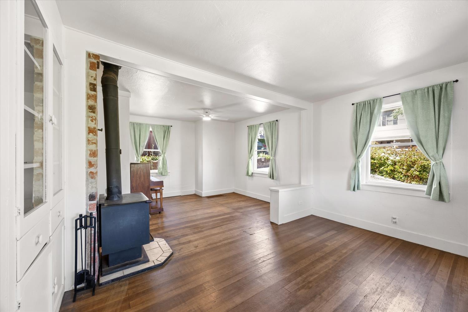2940 Conrad Street Placerville, CA 95667 - Photo 8 of 34 an empty room with wooden floor and windows