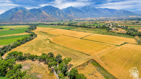19 East Southfield Road Spanish Fork, UT 84660 - Photo 13 of 74 Aerial view of sparsely populated area featuring a mountain backdrop and abundant farmland