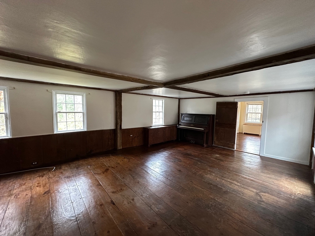 333 Dedham Street Dover, MA 02030 - Photo 12 of 24 an empty room with wooden floor and windows