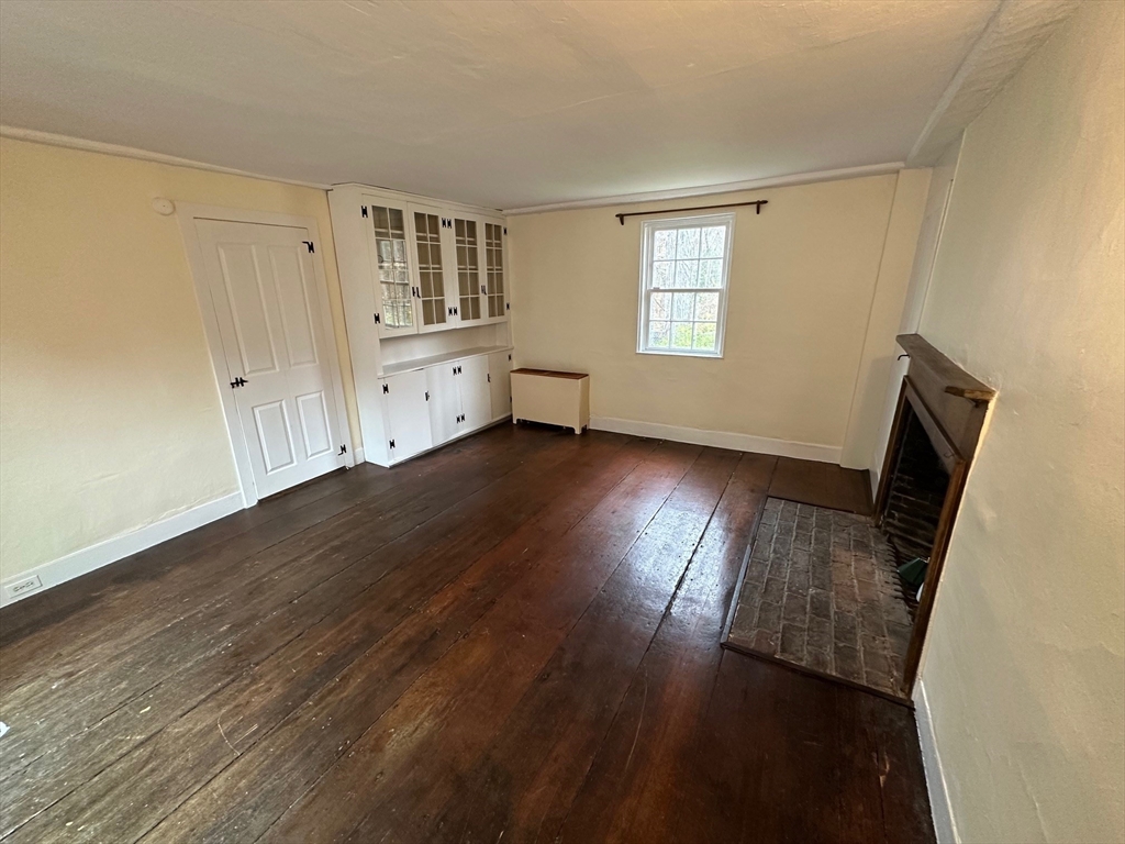 333 Dedham Street Dover, MA 02030 - Photo 13 of 24 a view of an empty room with wooden floor and a window