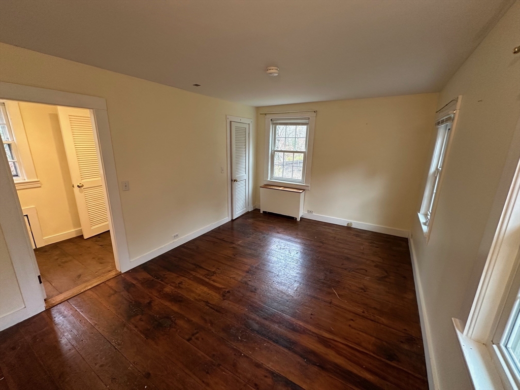 333 Dedham Street Dover, MA 02030 - Photo 20 of 24 a view of an empty room with wooden floor and a window