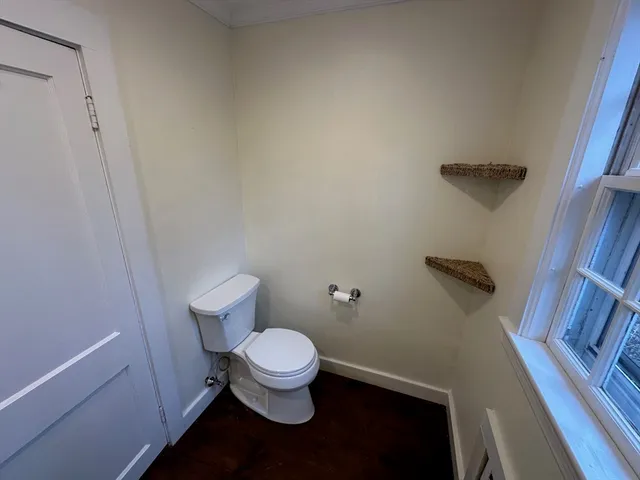 a white toilet sitting next to a shower