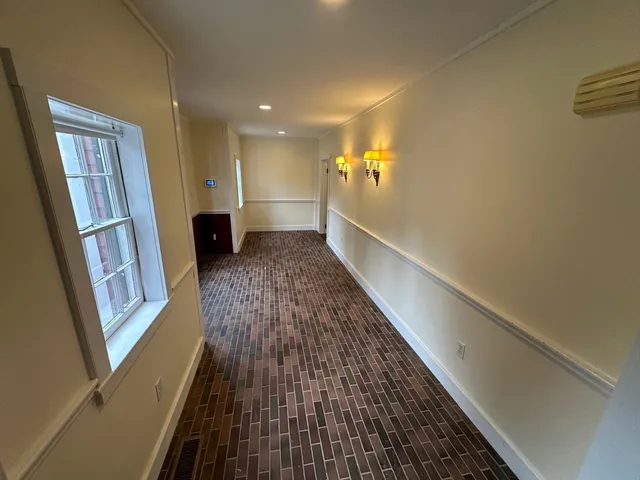 a view of gallery with wooden floor