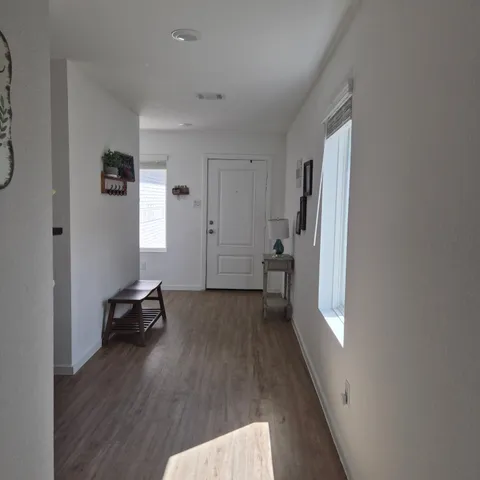 a view of a livingroom with wooden floor and a window