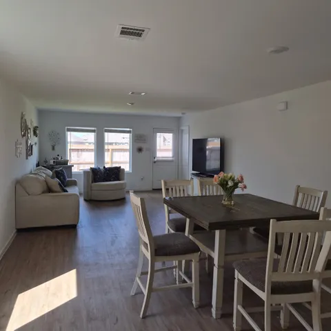 a view of a dining room with furniture and wooden floor
