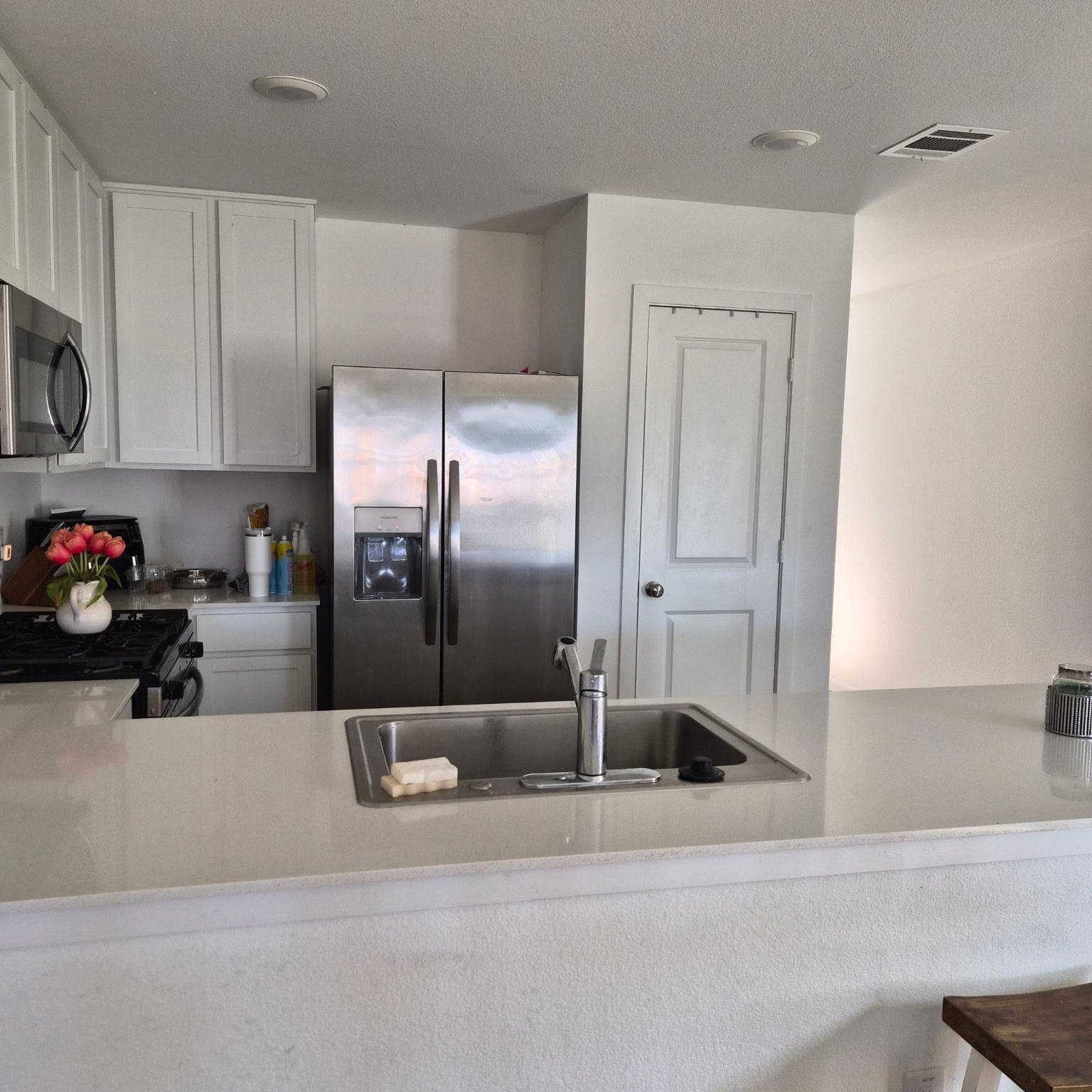 1723 Windrose Bend Angleton, TX 77515 - Photo 8 of 16 a kitchen with stainless steel appliances kitchen island granite countertop a refrigerator and a sink