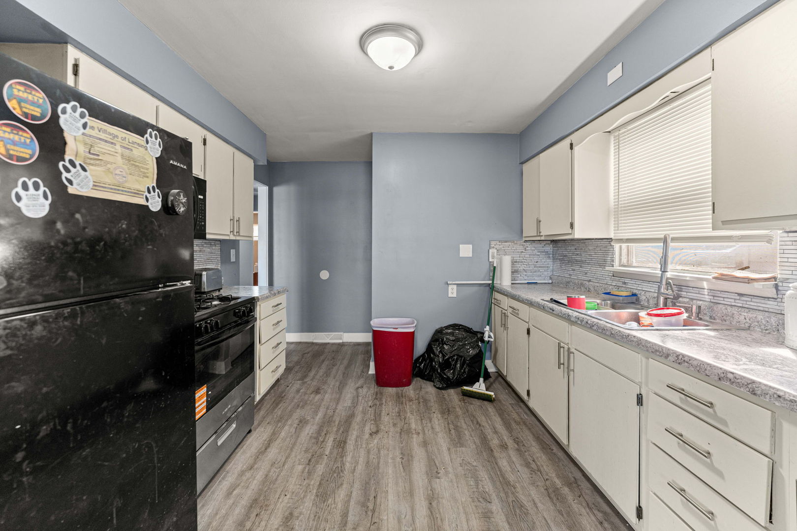 17831 Community Street Lansing, IL 60438 - Photo 9 of 22 a kitchen with a refrigerator and a stove