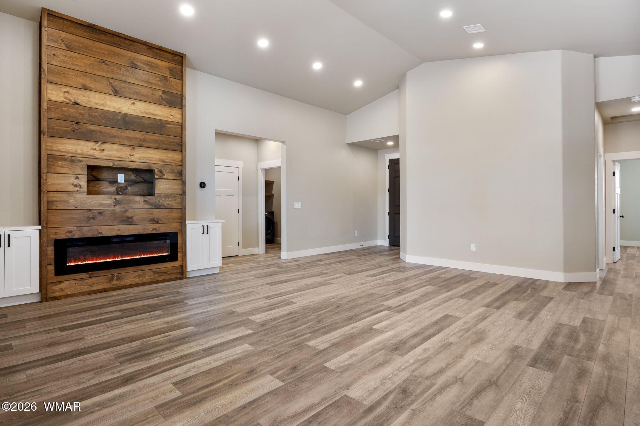 561 South Rock Ridge Drive Show Low, AZ 85901 - Photo 3 of 28 a view of an empty room with wooden floor and a fireplace