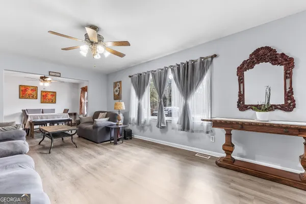 a living room with furniture gym equipment and a large window