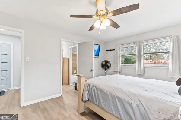 a bedroom with a large bed and a window