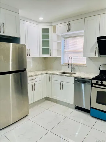 a kitchen with a sink appliances and cabinets