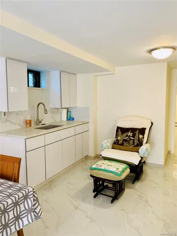 a living room with furniture and a sink