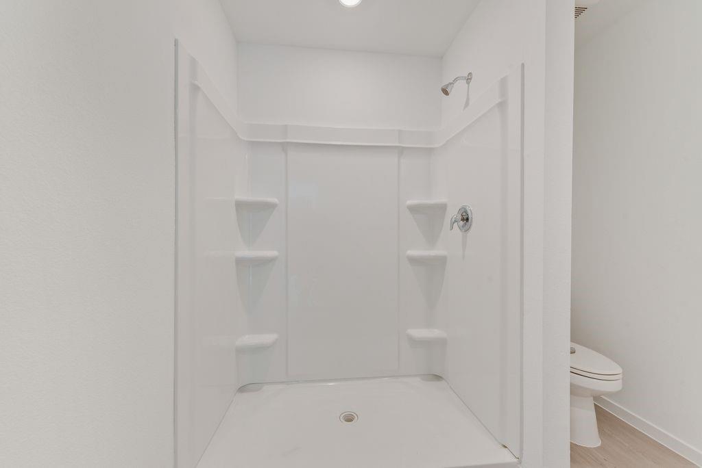 245 Boxberry Way Princeton, TX 75407 - Photo 21 of 23 a bathroom with a shower and toilet