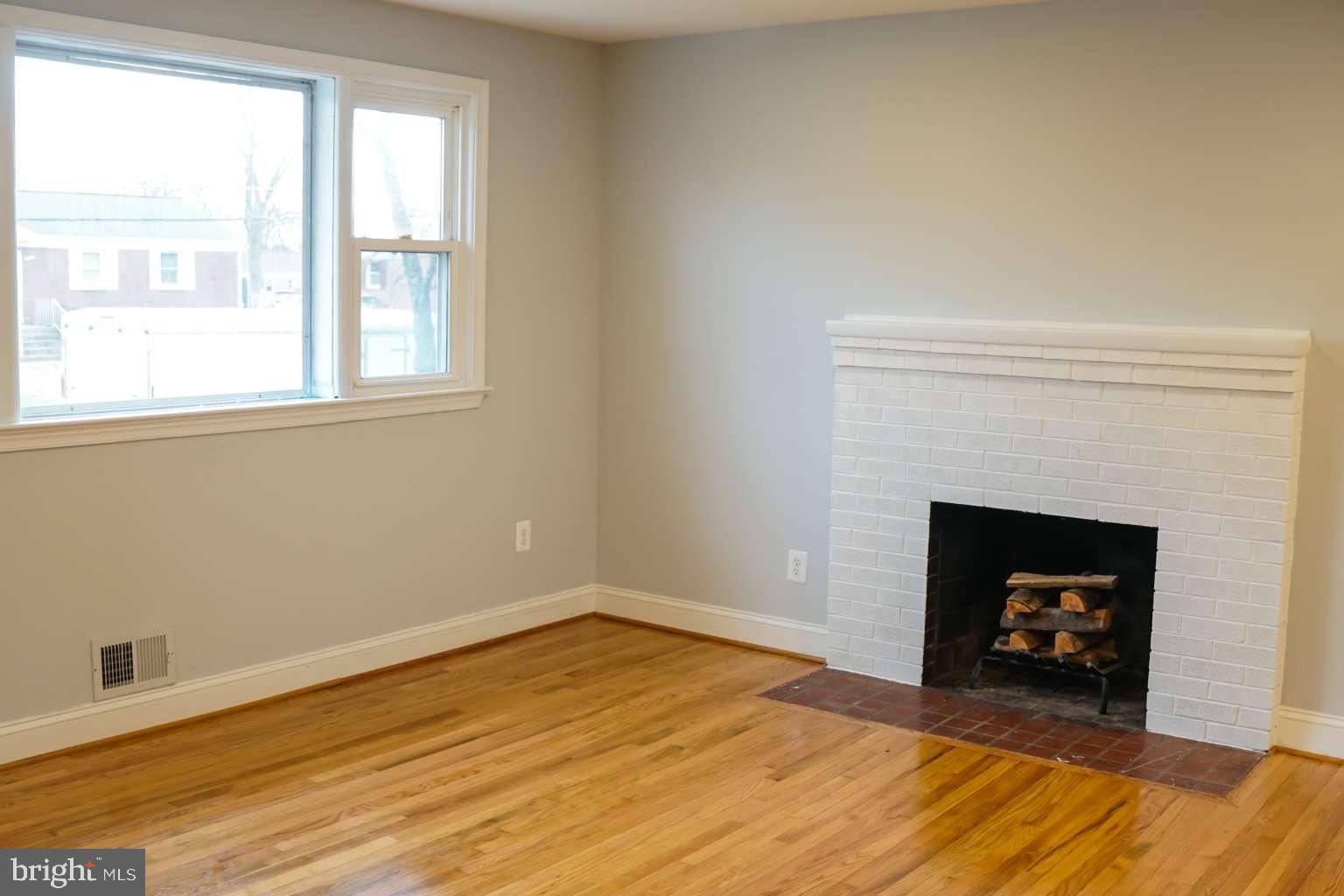 7107 Loch Raven Road Temple Hills, MD 20748 - Photo 11 of 36 a room with a fireplace and a fireplace