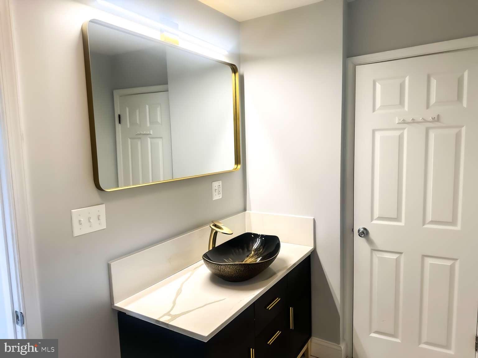 7107 Loch Raven Road Temple Hills, MD 20748 - Photo 13 of 36 a bathroom with a sink and a mirror