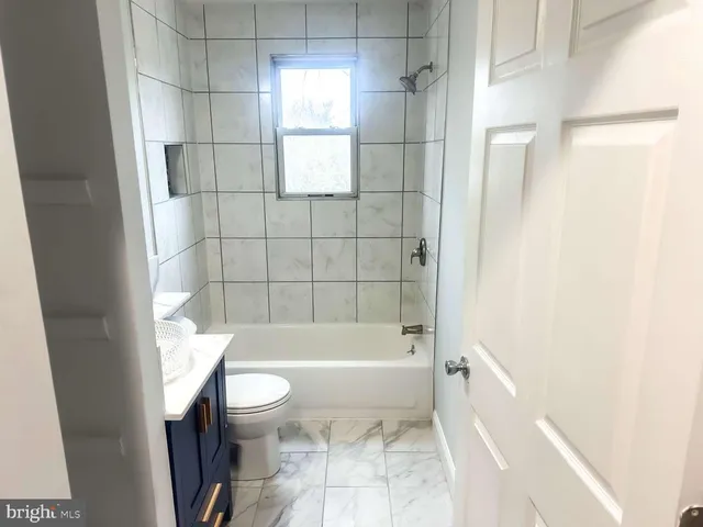 a bathroom with a bathtub and toilet
