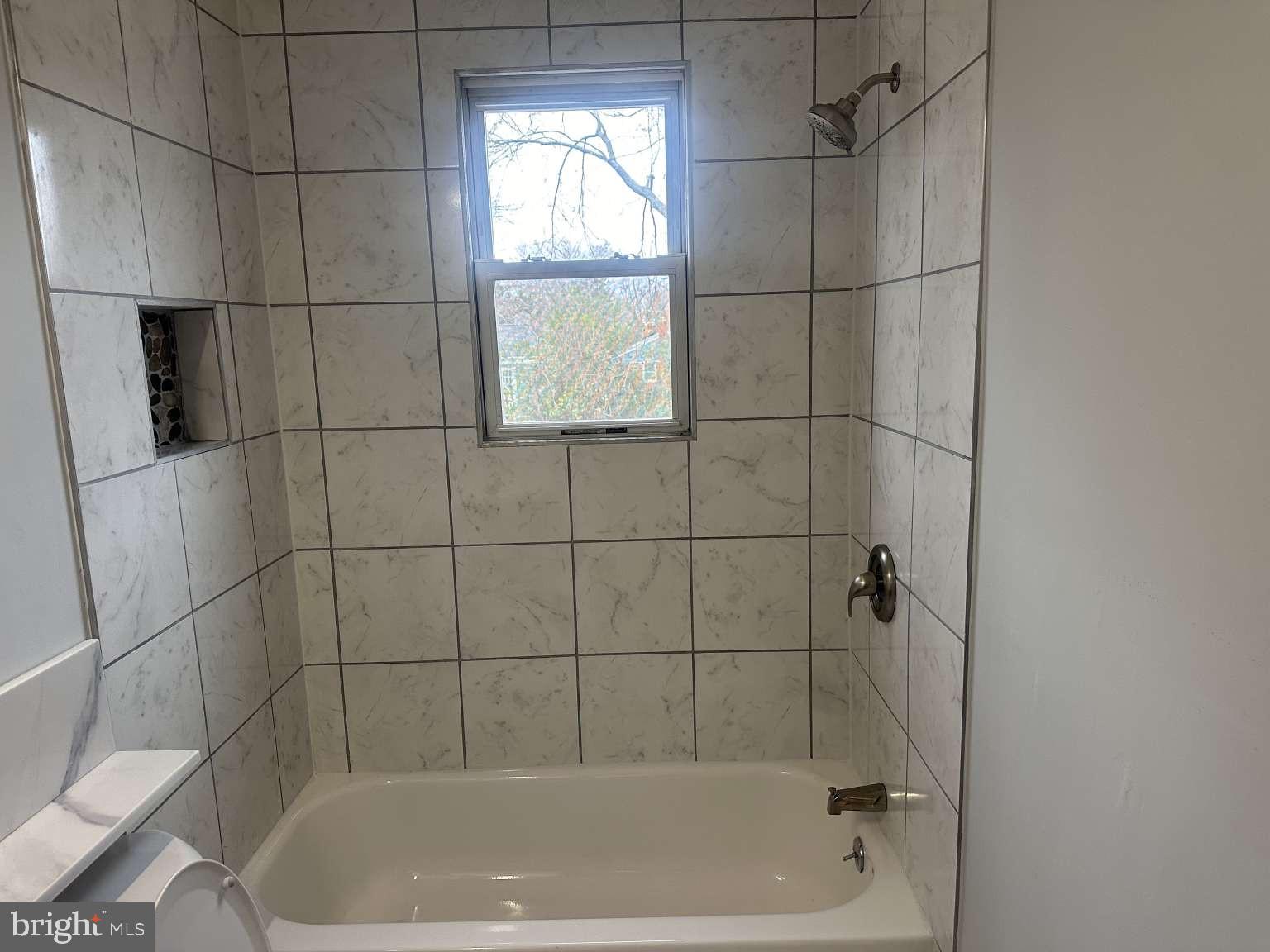 7107 Loch Raven Road Temple Hills, MD 20748 - Photo 17 of 36 a bath tub sitting next to a window