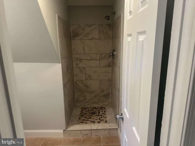a bathroom with a glass door shower and vanity