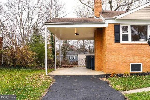 a view of a house with a yard and potted plants