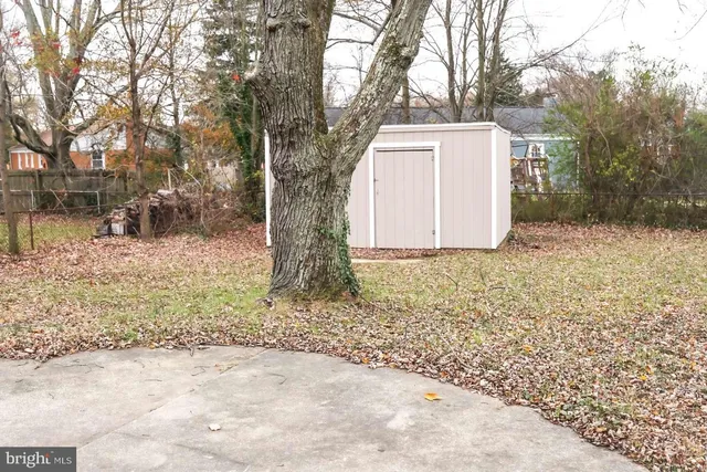 a view of a yard with snow on the road