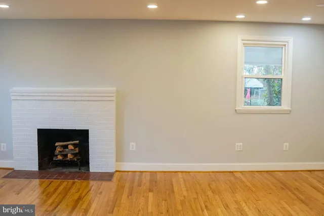 a view of an empty room with a fireplace