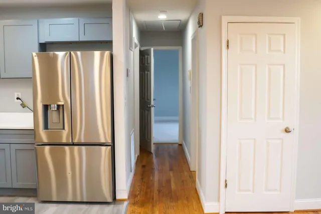 a view of a kitchen with wooden floor and staircase
