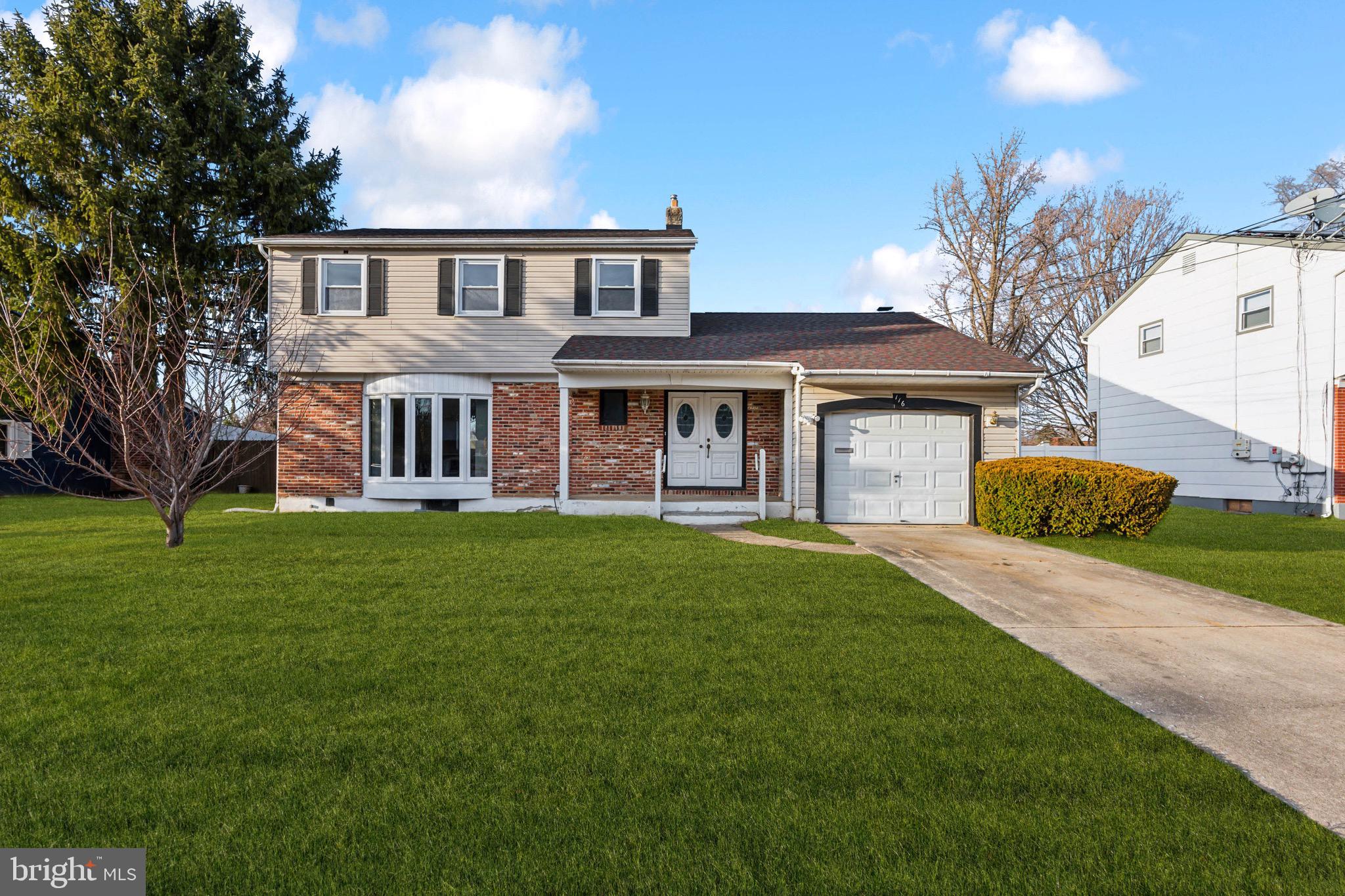 116 Colonial Road Beverly, NJ 08010 - Photo 1 of 25 a front view of a house with a garden