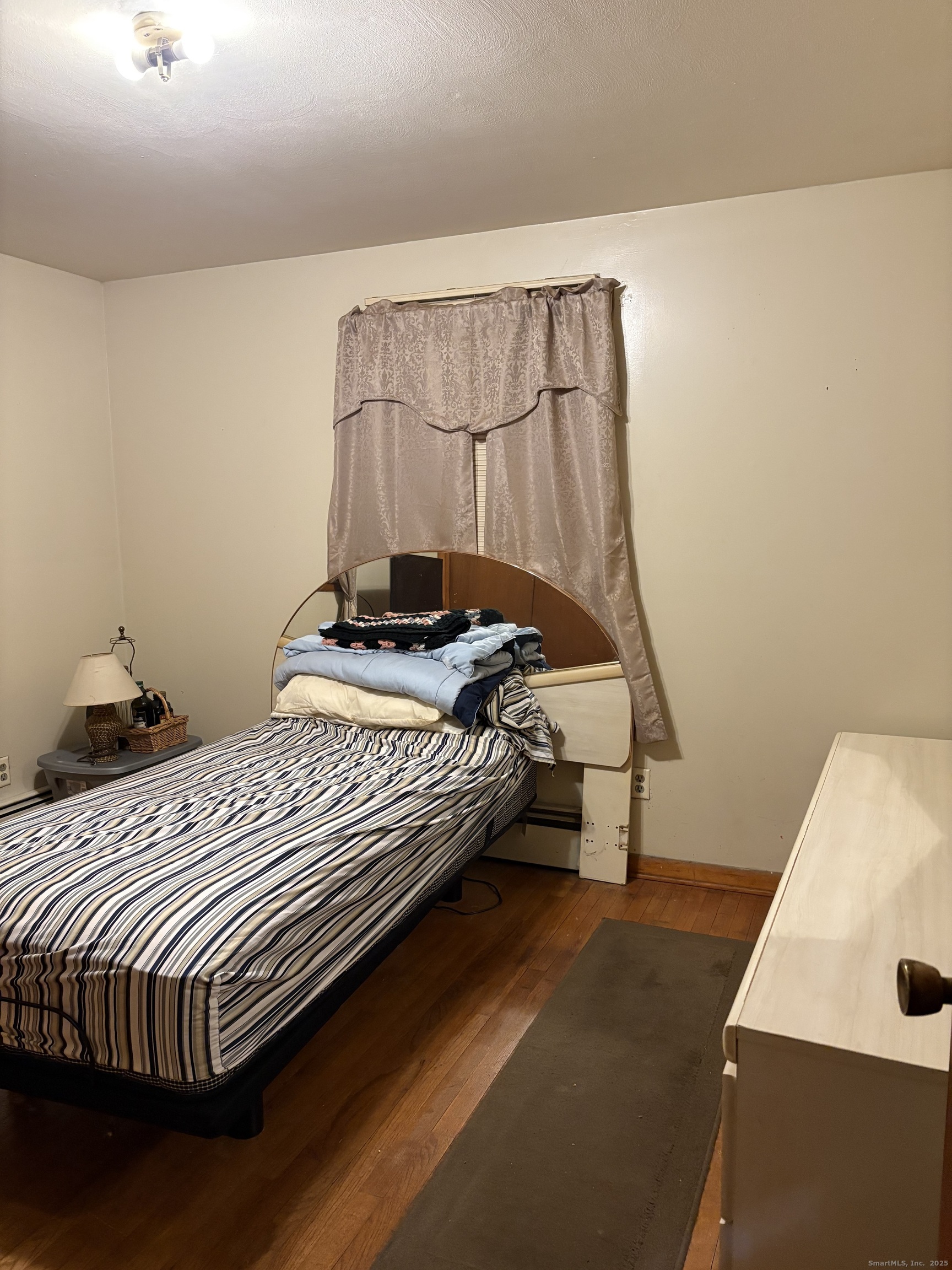 394 Harding Avenue Stratford, CT 06615 - Photo 11 of 11 a bedroom with a bed and wooden floor