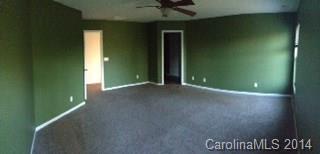 11910 Bending Branch Road Charlotte, NC 28227 - Photo 9 of 16 an empty room with a mirror