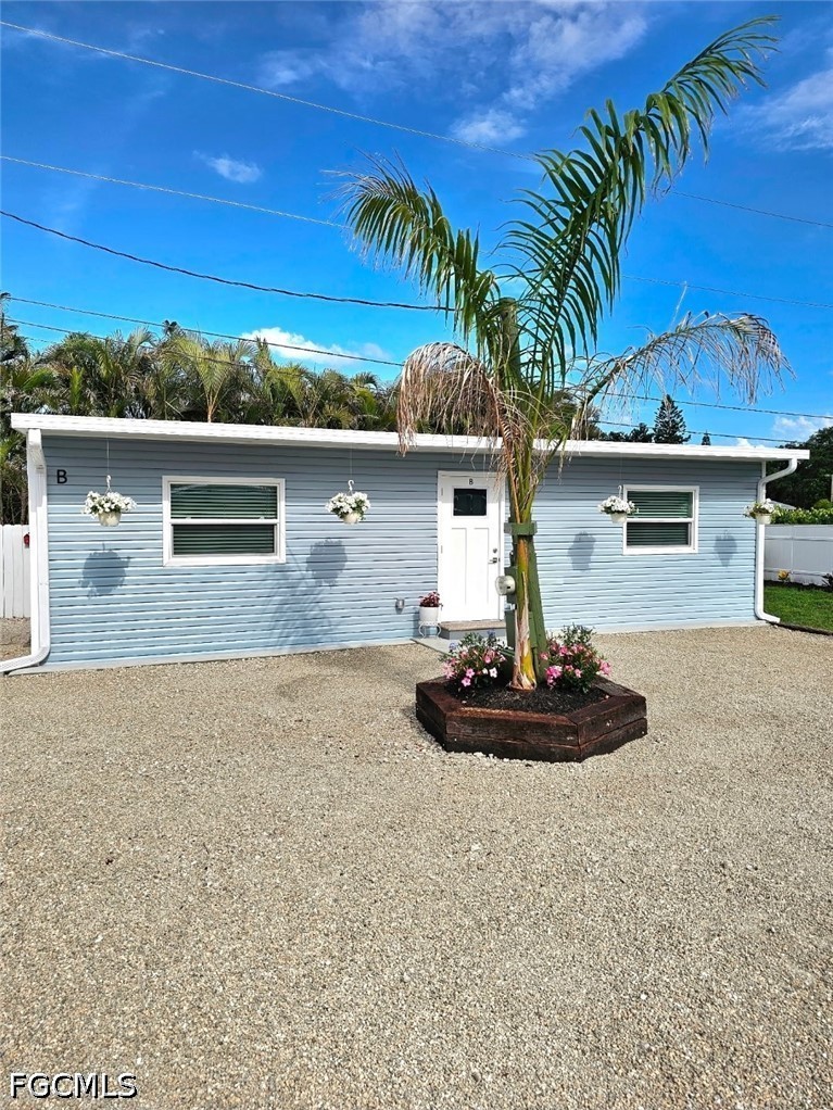 1130 Patterson Road Cape Coral, FL 33909 - Photo 14 of 21 a front view of a house with garden