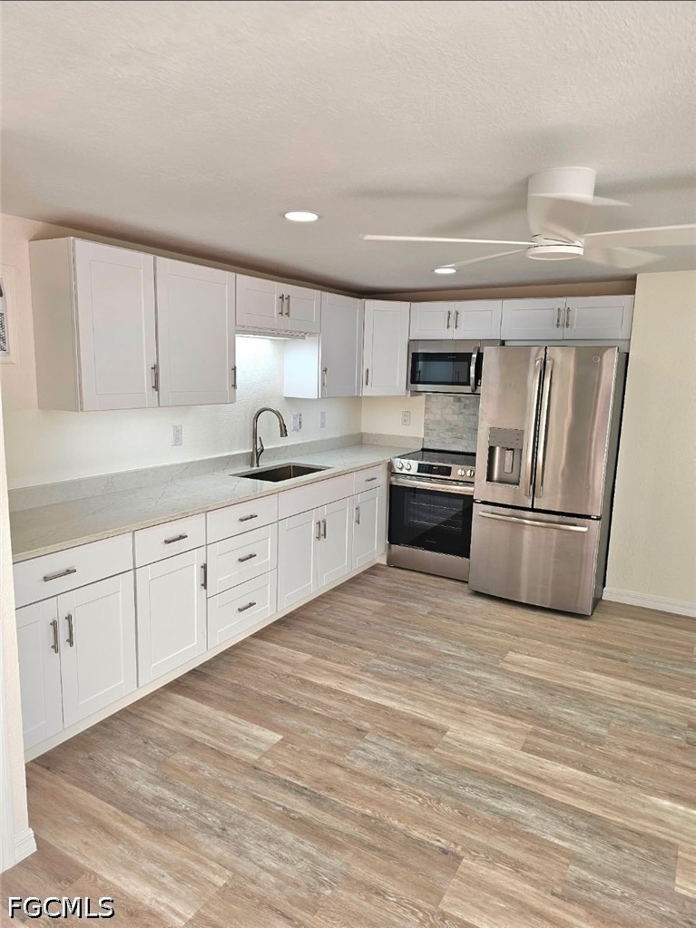 1130 Patterson Road Cape Coral, FL 33909 - Photo 15 of 21 a kitchen with granite countertop a refrigerator sink and cabinets