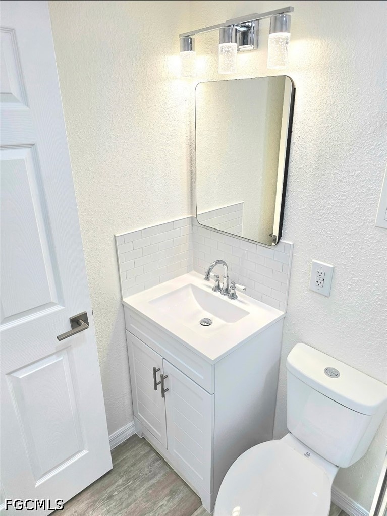 1130 Patterson Road Cape Coral, FL 33909 - Photo 19 of 21 a bathroom with a sink toilet and mirror