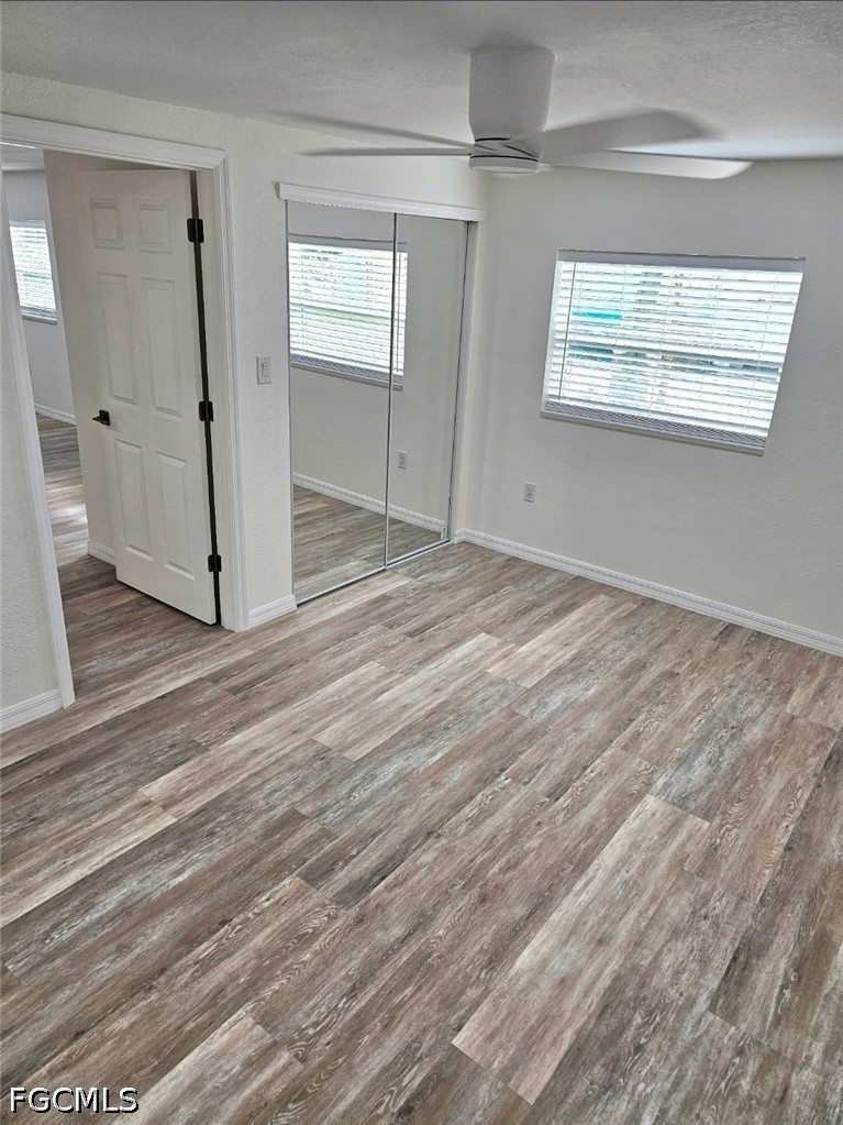 1130 Patterson Road Cape Coral, FL 33909 - Photo 20 of 21 an empty room with wooden floor and windows