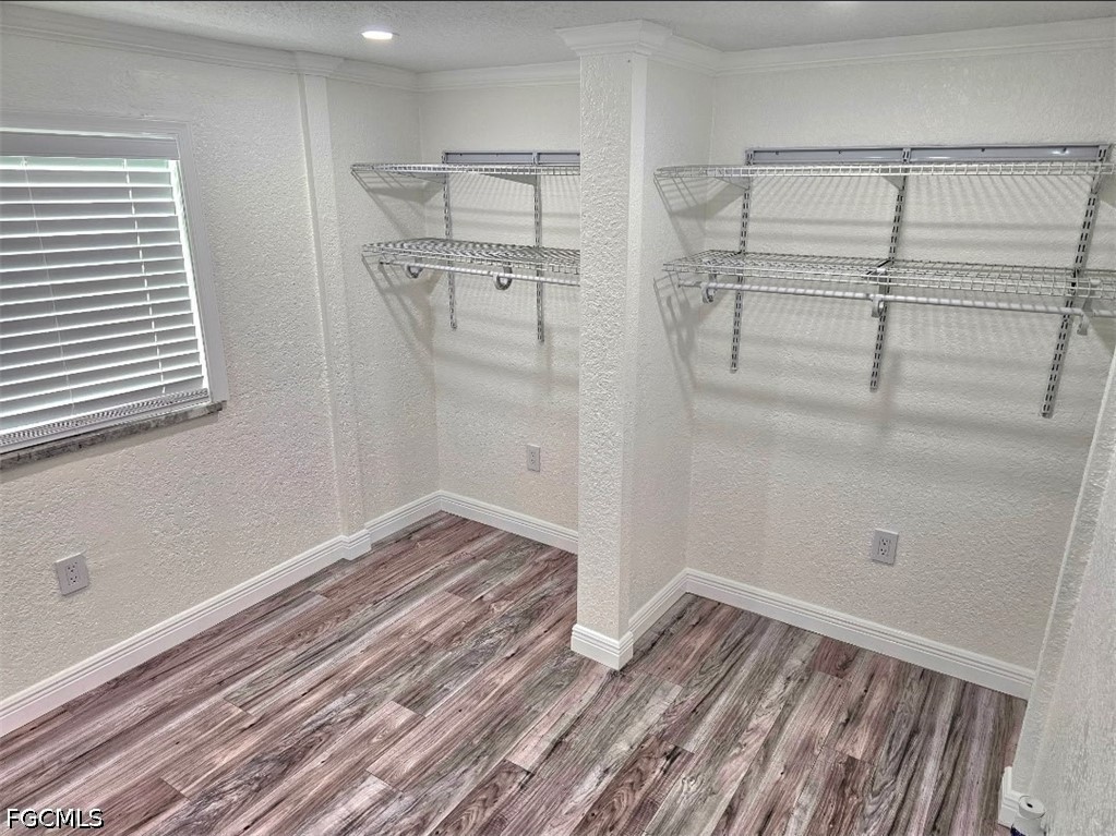 1130 Patterson Road Cape Coral, FL 33909 - Photo 9 of 21 a view of empty room with wooden floor and fan