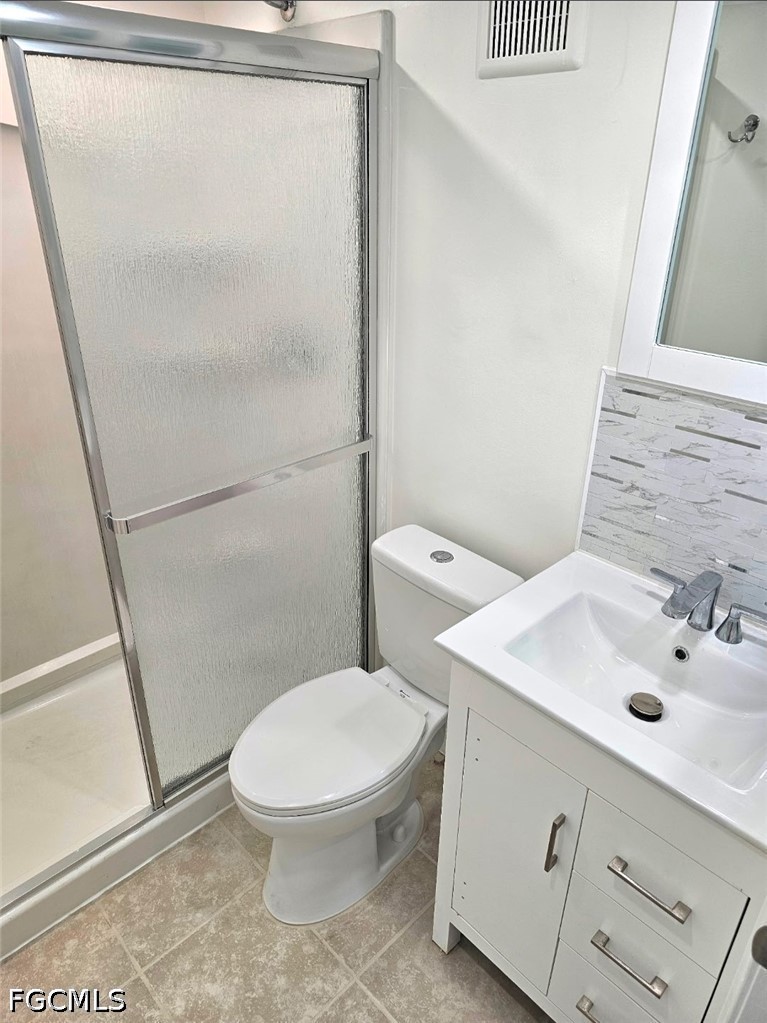 1130 Patterson Road Cape Coral, FL 33909 - Photo 10 of 21 a white toilet sitting next to a bathroom sink