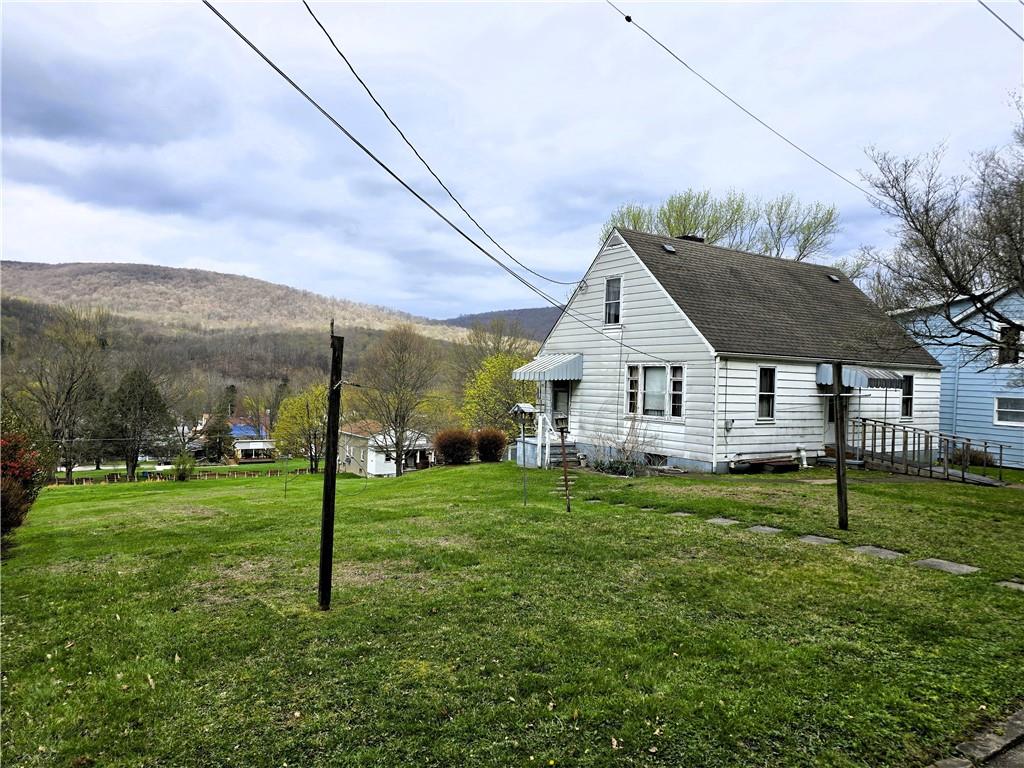 a house view with a play ground in front of it