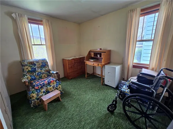 a bedroom with furniture and a window