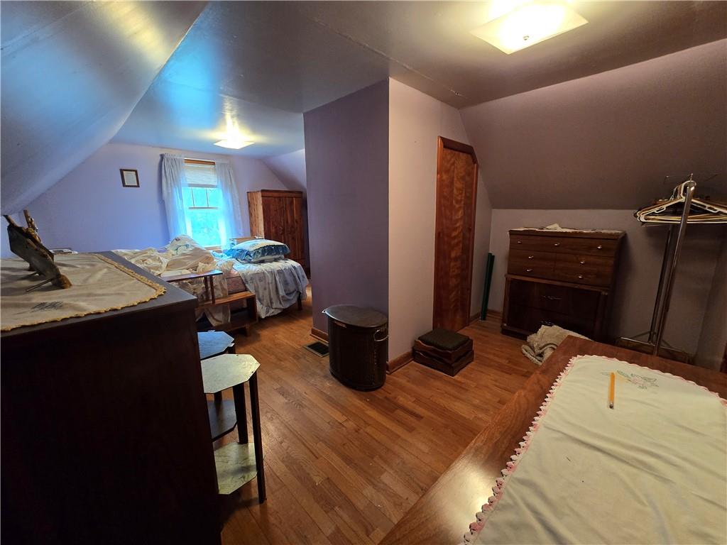 908 Walnut Street Bolivar, PA 15923 - Photo 14 of 25 a bedroom with a bed and wooden floor
