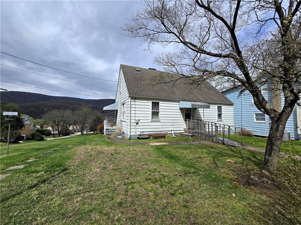 908 Walnut Street Bolivar, PA 15923 - Photo 2 of 25 a backyard of a house with table and chairs