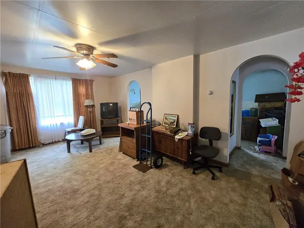 a living room with furniture a piano and a fireplace