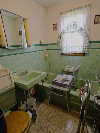 a bathroom with a sink mirror and toilet