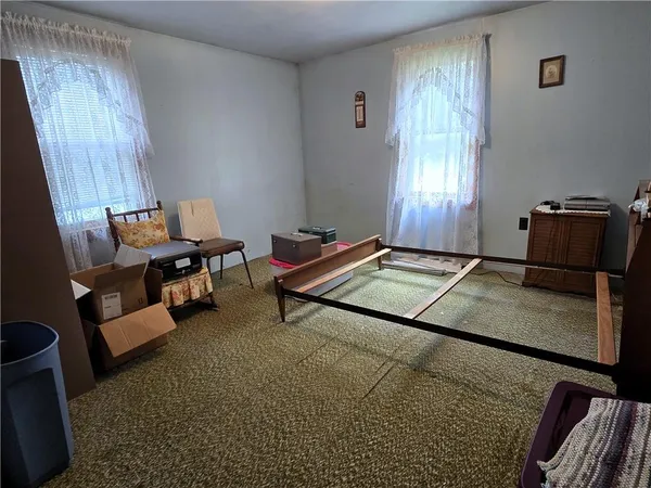 a living room with furniture rug and window