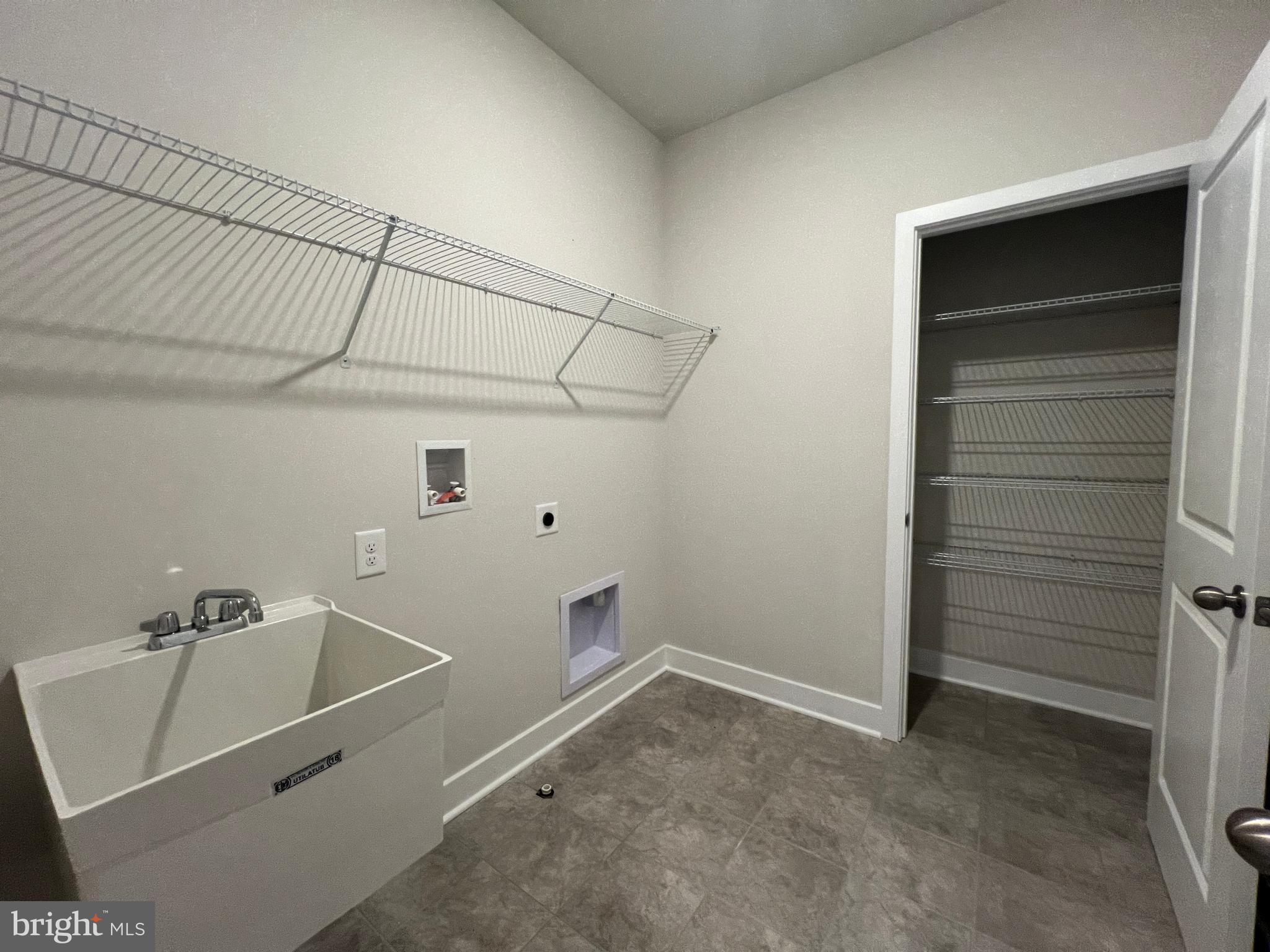 32707 Bar Harbor Road Lewes, DE 19958 - Photo 8 of 28 first floor laundry, storage closet, and sink