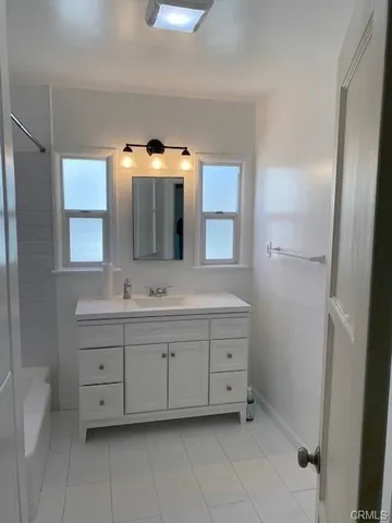 a bathroom with a double vanity sink and mirror